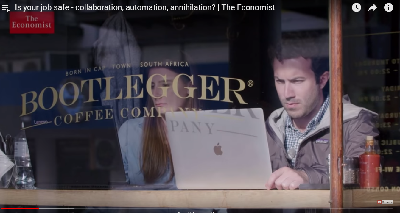 Workers in a coffee shop on laptops